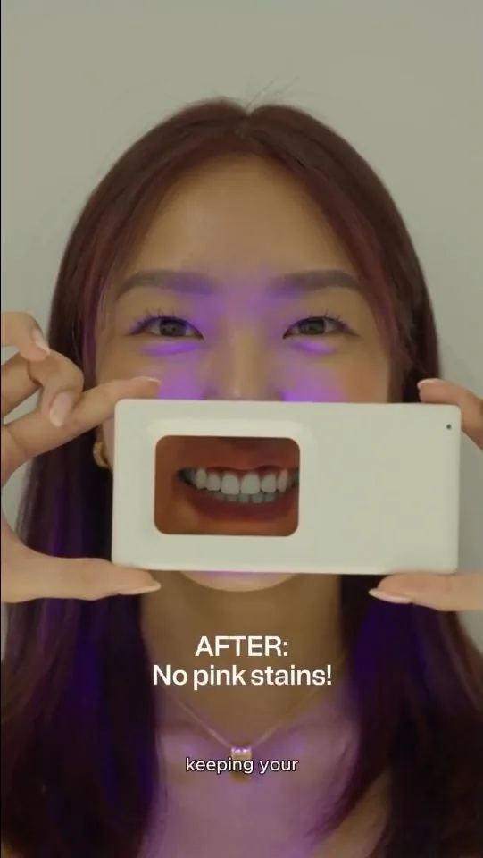 Person holding a plaque-light viewer displaying teeth, image 03