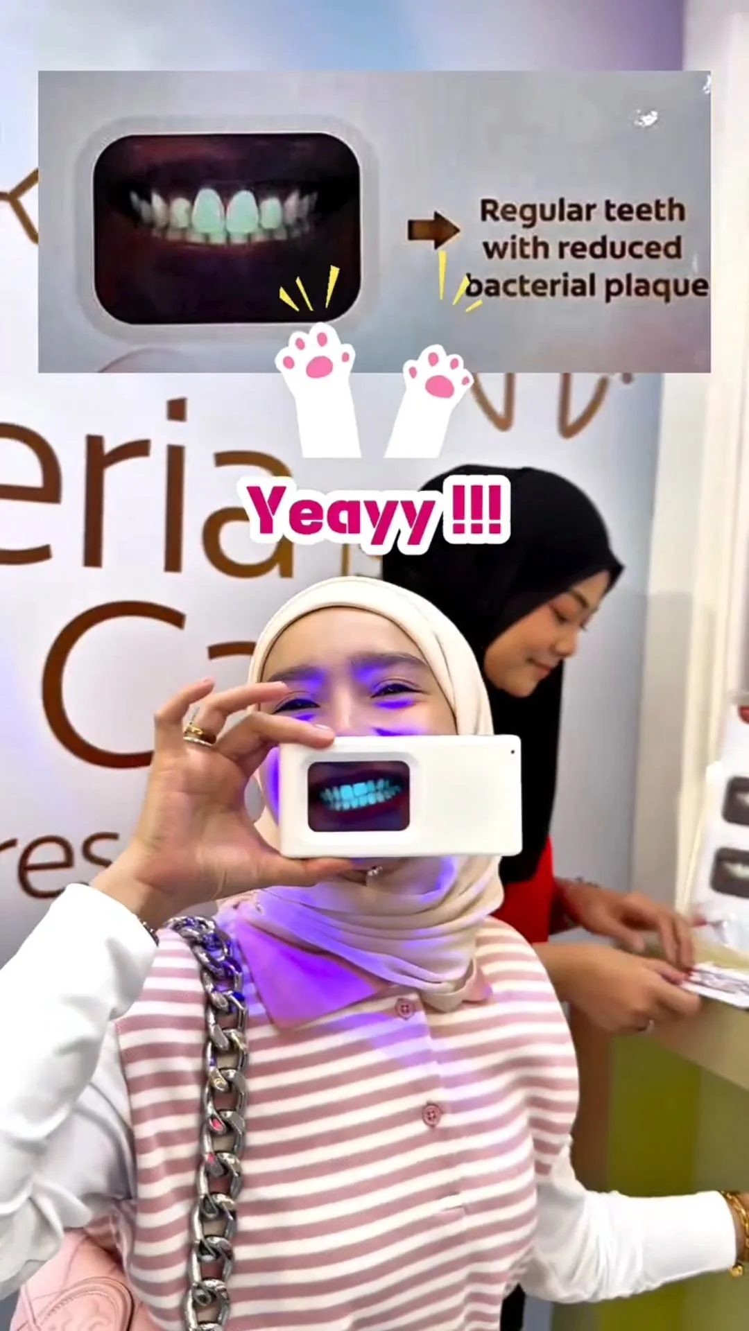 Person holding a plaque-light viewer displaying teeth, image 12