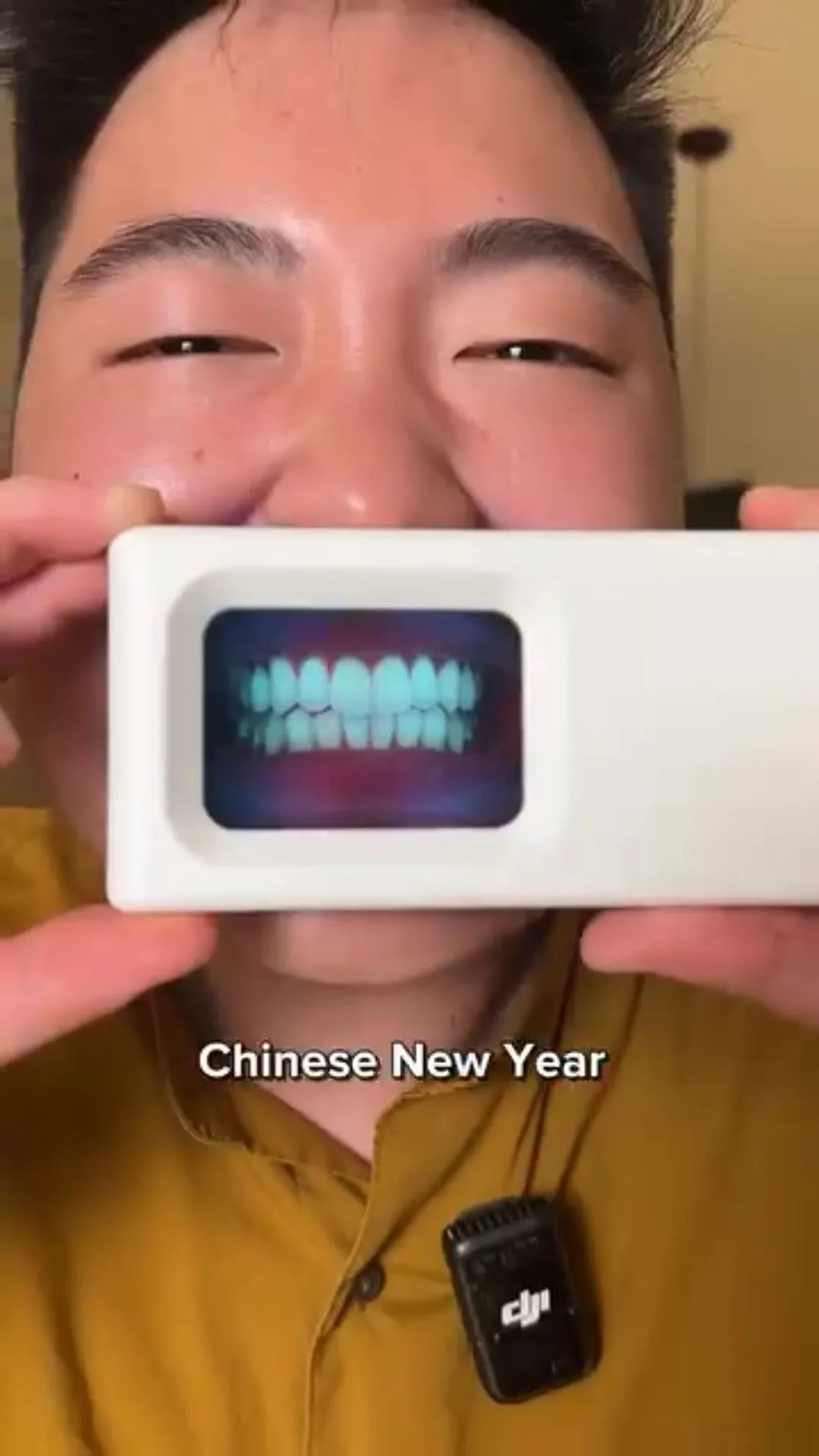 Person holding a plaque-light viewer displaying teeth, image 26