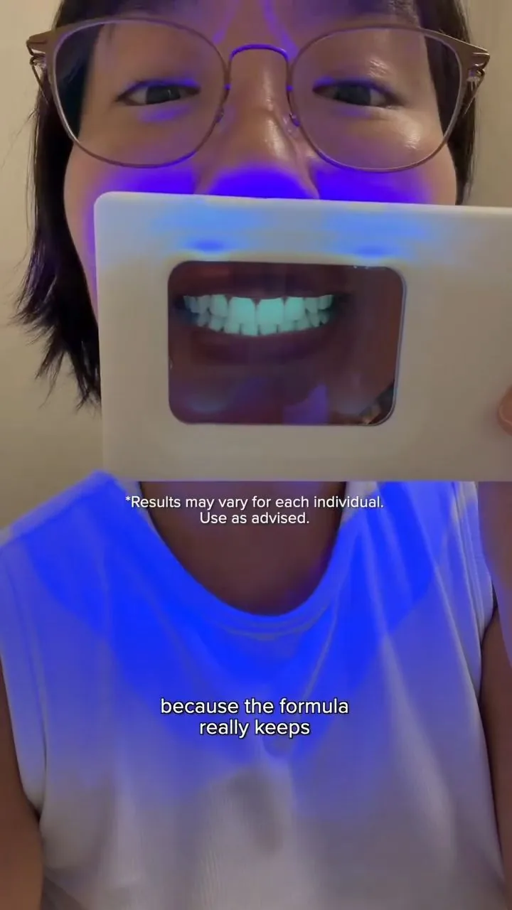 Person under violet illumination during a plaque-light demonstration, image 36