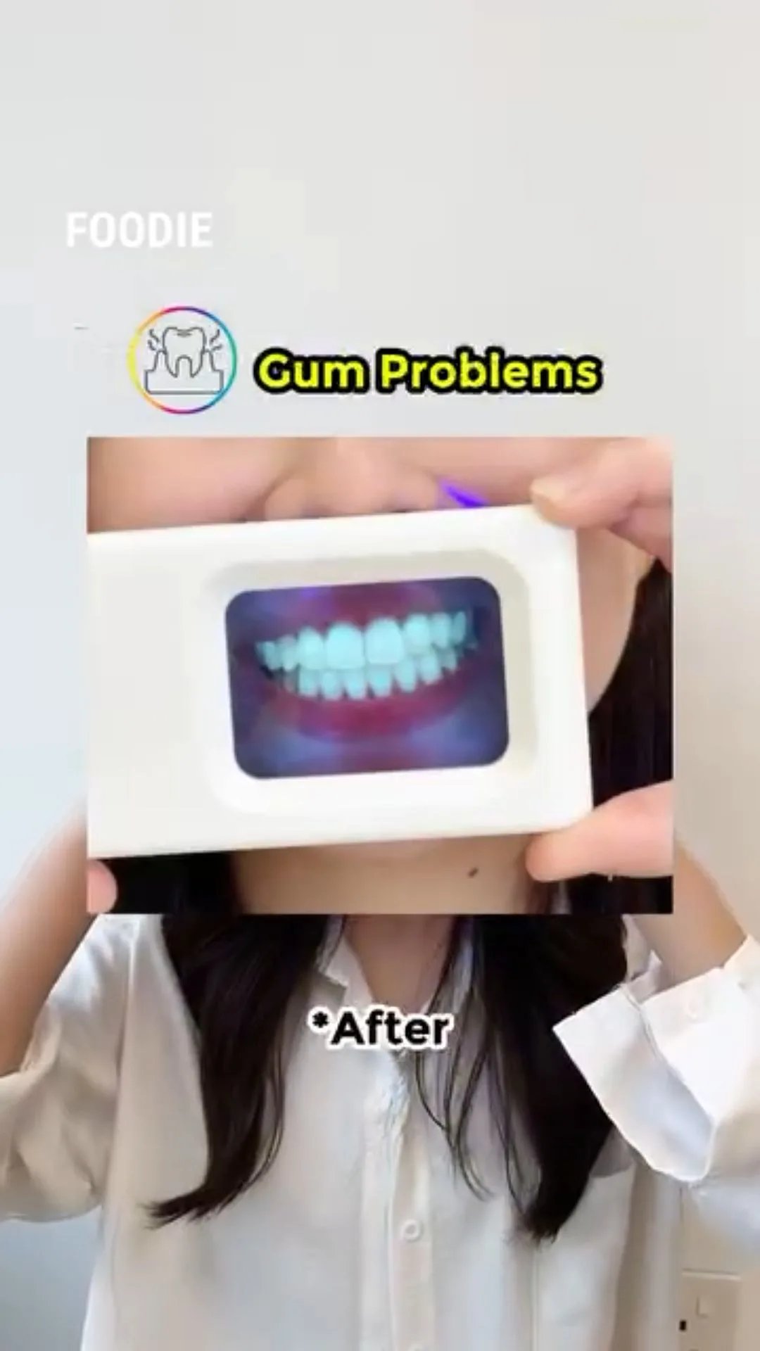 Person holding a plaque-light viewer displaying teeth, image 50